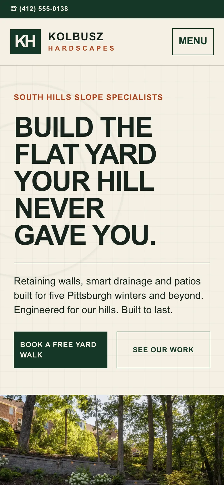Kolbusz Hardscapes home page on a phone, built by Theo: the number in a dark bar across the top, the headline about a flat yard, and Book a free yard walk under it